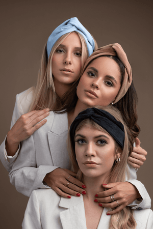 
                  
                    three women wearing the sultany bandeau headbands
                  
                